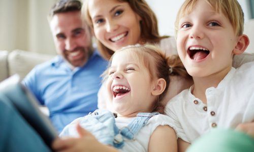 Children sitting together with parents and laughing